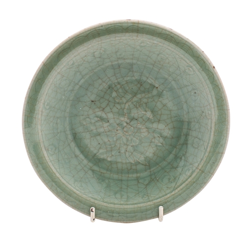 69 - A Chinese Longquan dish with crackled celadon glaze, everted rim and on short foot, moulded with a c... 