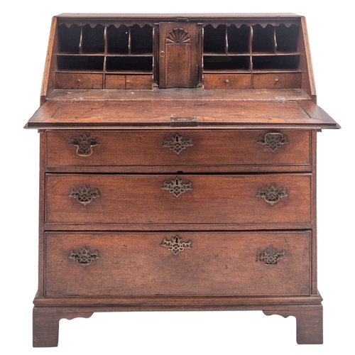 798 - A George II oak bureau, mid 18th century; the sloping hinged and cleated fall front enclosing a fitt... 