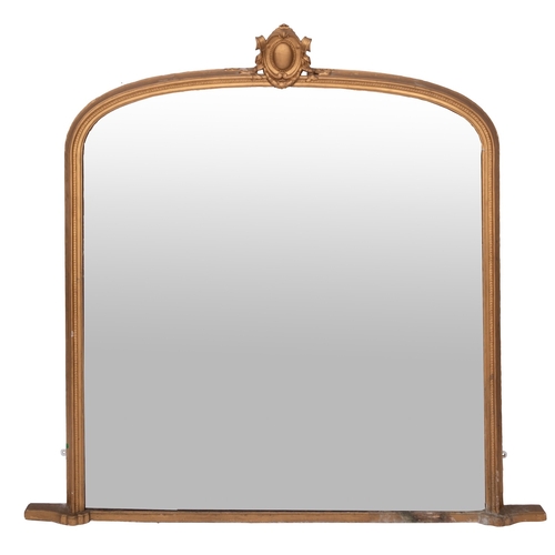 909 - A Victorian giltwood and composition framed overmantel mirror, circa 1875; of shallow arched form, w... 