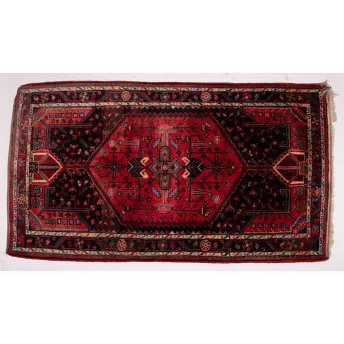 1070 - A Hamadan rug, the field with a central rose stepped hexagonal panel, all over designs and indigo su... 