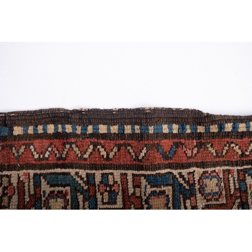 1075 - A Sehna Kelim runner, the rose stepped field with a row of eight ivory lozenge pointed medallions wi... 