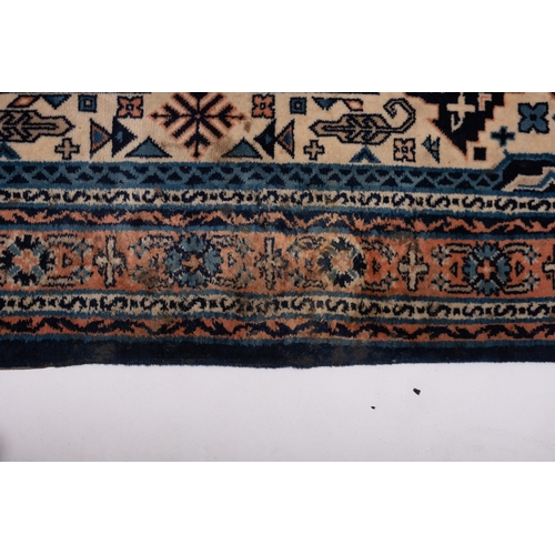 1076 - A Turkish carpet, the ivory stepped and pointed hexagonal field with rose and pastel blue flowerhead... 