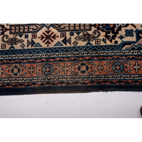 1076 - A Turkish carpet, the ivory stepped and pointed hexagonal field with rose and pastel blue flowerhead... 