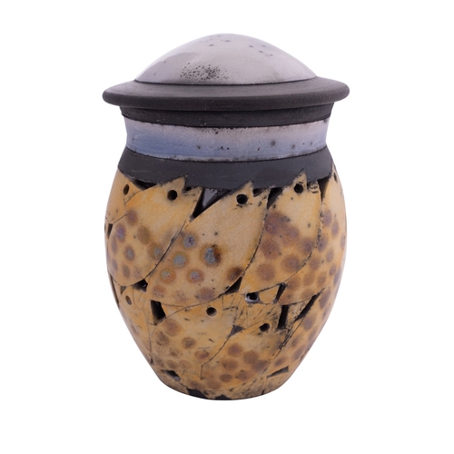 129 - Rob Whelpton [b. 1952] a raku fired stoneware jar and cover, of reticulated oviform, the exterior de... 