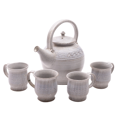 82 - A stoneware teapot and four cups, attributed to John Lomas, the former of globular form with applied... 