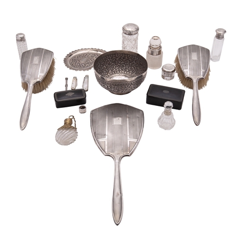 14 - A collection of silver and silver mounted items, including: a handled mirror and two brushes by Char... 