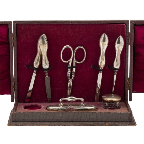 17 - A silver mounted manicure set by William Davenport, Birmingham 1924, in a fitted faux leather case, ... 