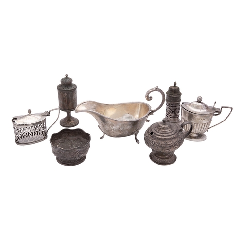 22 - A collection of silver condiments, to include: a mustard pot by Hilliard & Thomason, Birmingham 1918... 