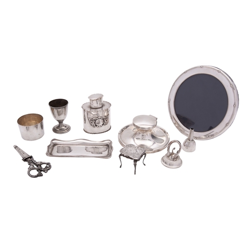 26 - A collection of silver and silver mounted items, including: a circular photograph frame by Carr's of... 