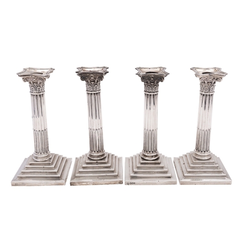 321 - A pair of Edwardian silver Corinthian column candlesticks by The Goldsmiths & Silversmiths Co. Ltd, ... 