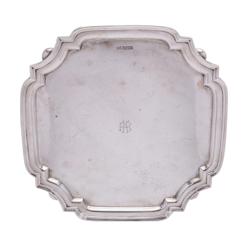 330 - An Elizabeth II silver salver by Walker and Hall, Sheffield 1960, of scalloped square form raised on... 