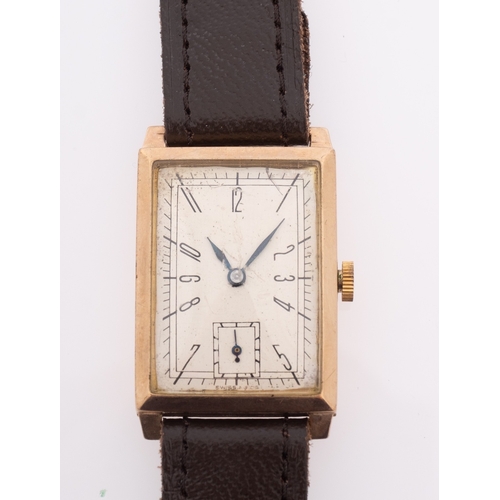 407 - A gentlemen's 9ct gold wristwatch the rectangular dial with stylised black Roman numerals and subsid... 