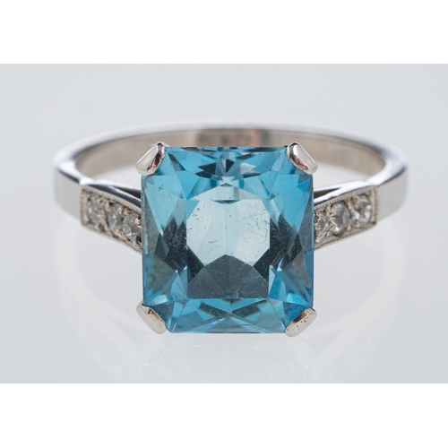 482 - A platinum dress ring set with a mixed cut aquamarine, the shoulders set with small diamonds in mill... 