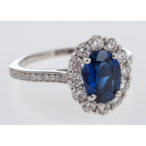 486 - A fine quality Garrards sapphire and diamond ring, the central oval deep blue faceted sapphire of go... 