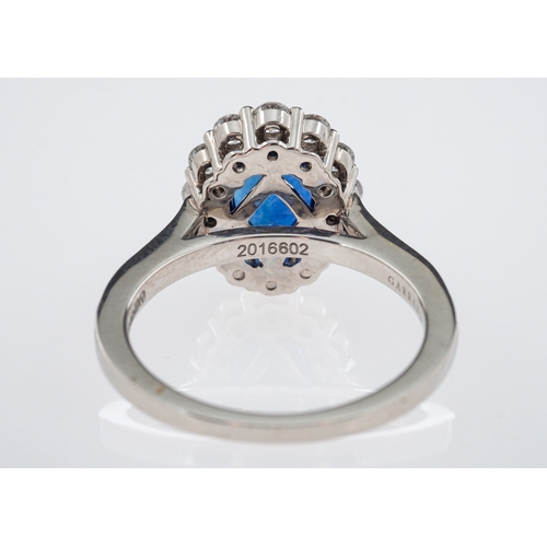 486 - A fine quality Garrards sapphire and diamond ring, the central oval deep blue faceted sapphire of go... 