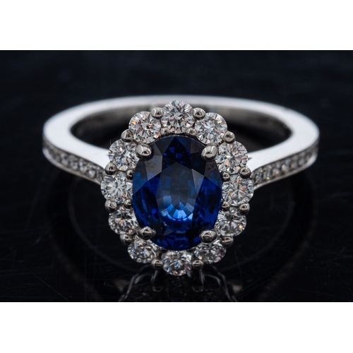 486 - A fine quality Garrards sapphire and diamond ring, the central oval deep blue faceted sapphire of go... 