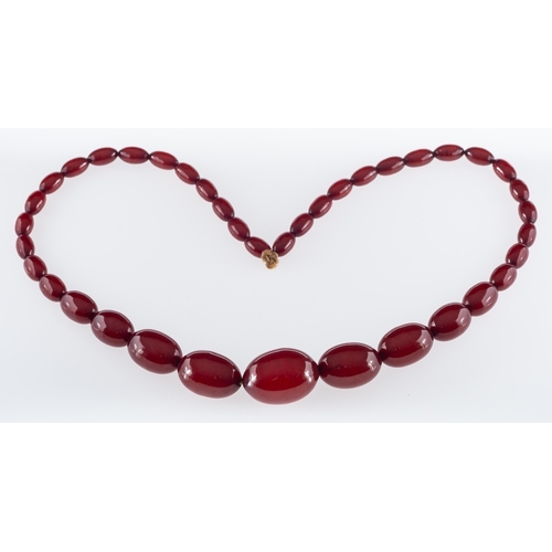 496 - A 1920's cherry Bakelite type necklace, the oval beads graduating in size.