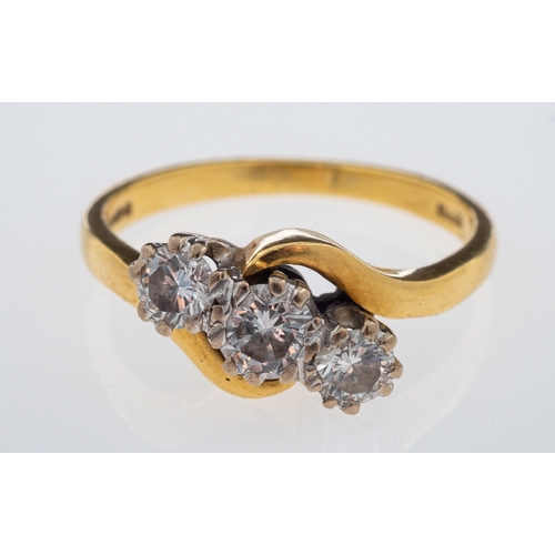 539 - A three stone diamond ring, set with brilliant cut diamonds in crossover design mount, 18ct gold, ri... 