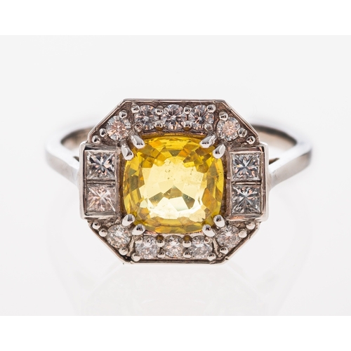 542 - A plaque ring of octagonal form set with a yellow sapphire within a border of brilliant cut diamonds... 