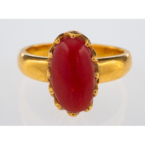 549 - A vintage hand crafted ring set with cabochon form coral, in high carat gold, ring size L