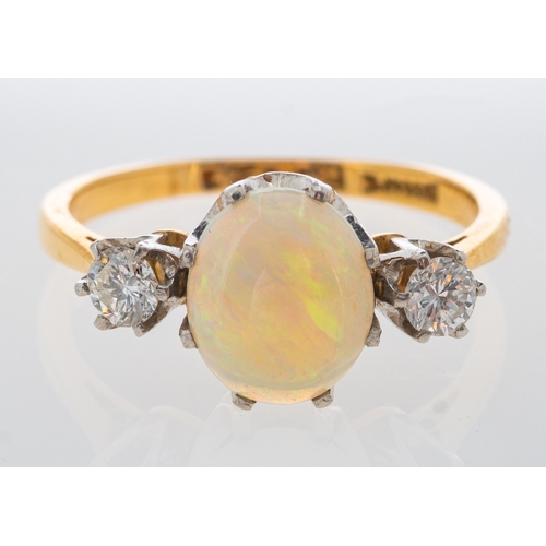 550 - An opal and diamond ring in yellow gold, total diamond weight estimated at 0.30 carat, ring size J