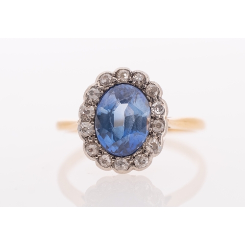 557 - A sapphire & diamond ring, the oval faceted sapphire of good colour measuring 8.5 x 6.5 mm, set in a... 