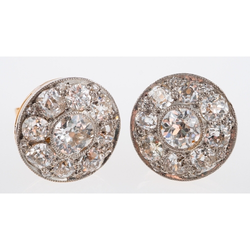 566 - An  Edwardian diamond set earrings, set with old cut stones in a millgrain setting, the principle di... 