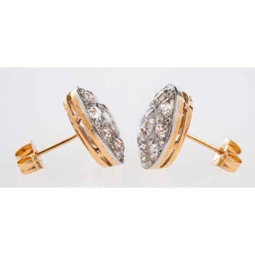 566 - An  Edwardian diamond set earrings, set with old cut stones in a millgrain setting, the principle di... 