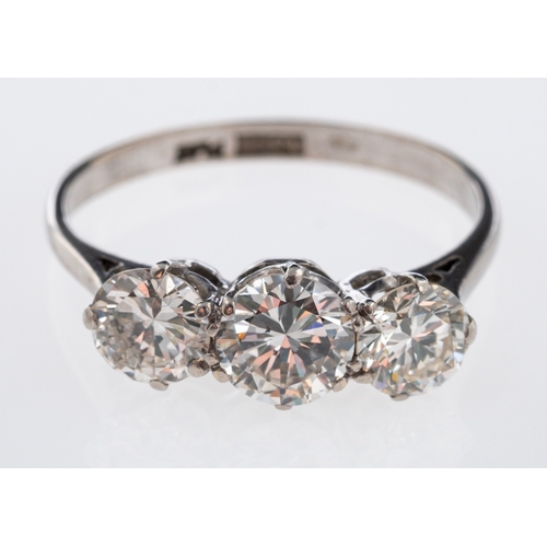 567 - A three stone diamond ring, the principle brilliant cut diamond of approximately 1 carat, total diam... 