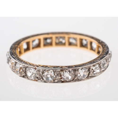 580 - A diamond eternity ring, set with old cut diamonds, with an engraved border, ring size N