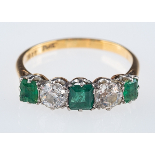 587 - An emerald and diamond ring, the three square cut emeralds with old brilliant cut diamonds, approxim... 