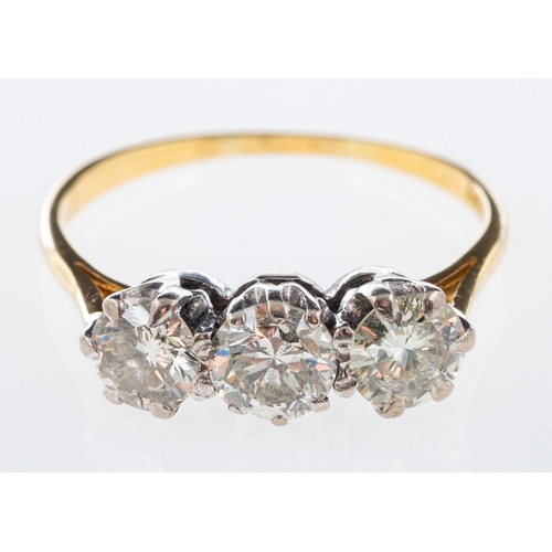 592 - A three stone diamond ring set with brilliant cut diamonds in 18ct white and yellow gold, total diam... 