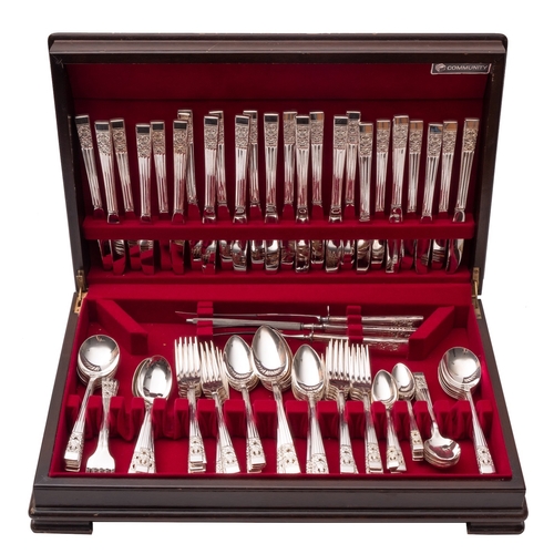 6 - A silver plated canteen of Community flatware, place setting for twelve, in a stained oak and walnut... 