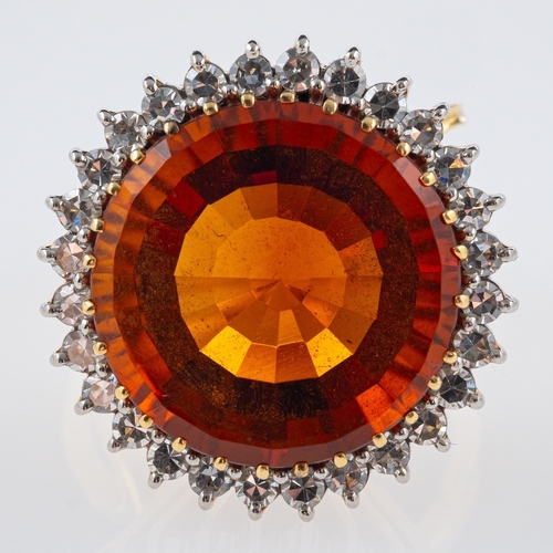 608 - A Vintage Madeira citrine cocktail ring, the central stone of red to orange colour, within a border ... 