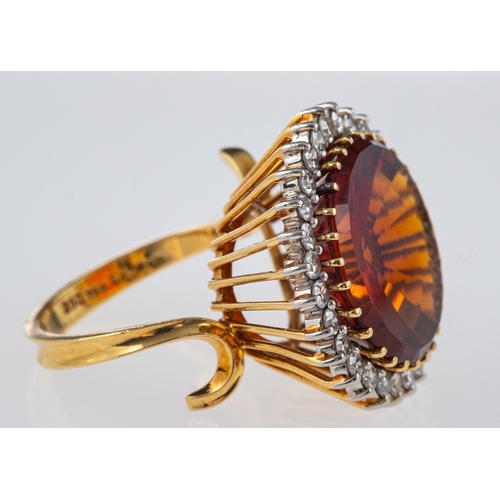 608 - A Vintage Madeira citrine cocktail ring, the central stone of red to orange colour, within a border ... 