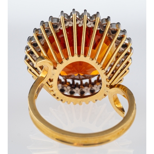 608 - A Vintage Madeira citrine cocktail ring, the central stone of red to orange colour, within a border ... 