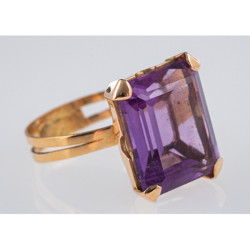 613 - A vintage cocktail ring set with a large amethyst in hand crafted gold mount, unmarked believed to b... 