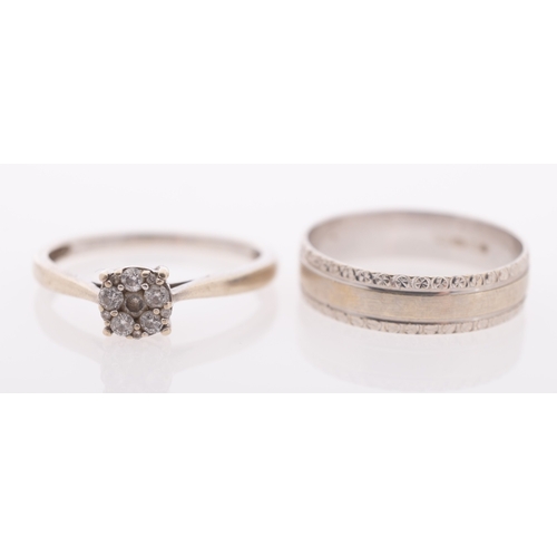 620 - Two white gold rings, a diamond cluster ring, and a gold band with relief decoration, both 9ct gold,... 