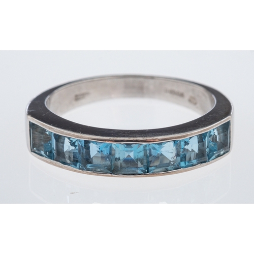 621 - A modern aquamarine set ring, the square cut stones channel set in 18ct white gold, ring size Q-R