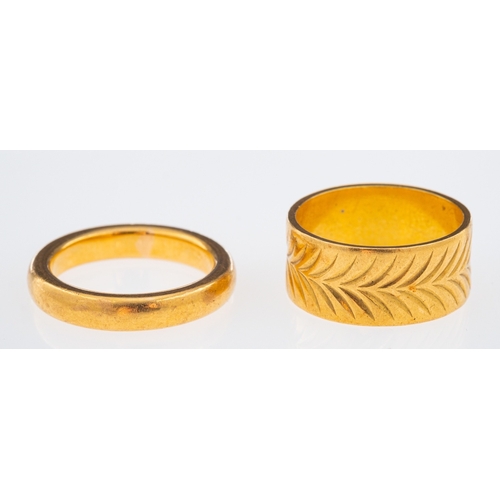 628 - A gold wedding band with chevron pattern leaf decoration, and a plain wedding ring both 22ct, ring s... 