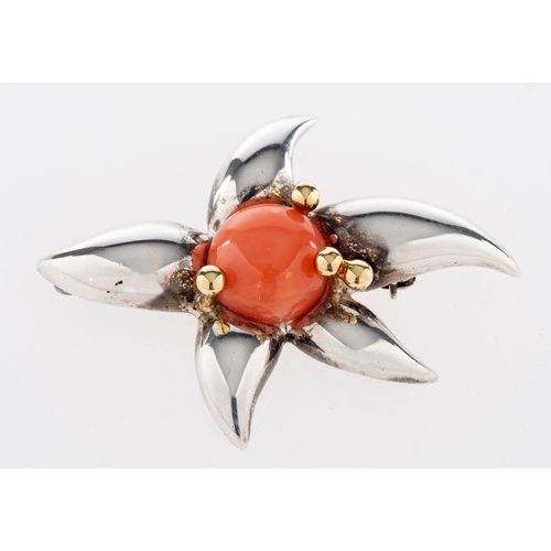 631 - A coral brooch by Tiffany & Co., circa 1993,  the circular cabochon coral with gold coloured bead de... 