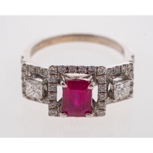 704 - A 1940's style ruby and diamond ring with central step cut ruby and square cut diamonds, all within ... 