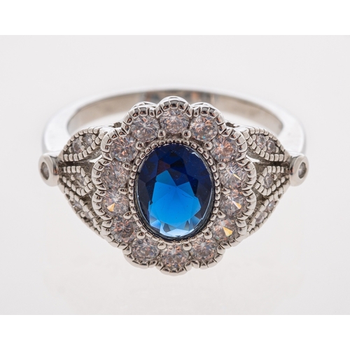 712 - A dress ring set with diamonds and synthetic sapphire in millgrain white gold setting, marks unclear... 