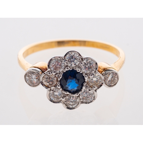 715 - A modern daisy set sapphire & diamond ring in 18ct gold. ring size M