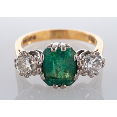 721 - An 18ct gold, emerald-cut emerald and round, brilliant-cut diamond, three-stone ring, estimated emer... 