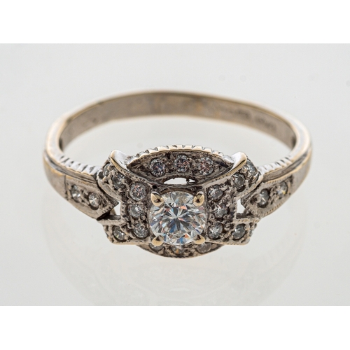 735 - A diamond cluster ring set in 18ct white gold, central stone estimated at 0.25 carats, 18ct white go... 