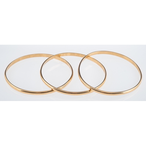 822 - Three yellow metal D form bangles, testing as 9ct gold, internal measurement 6cm, weight 34.6 grams