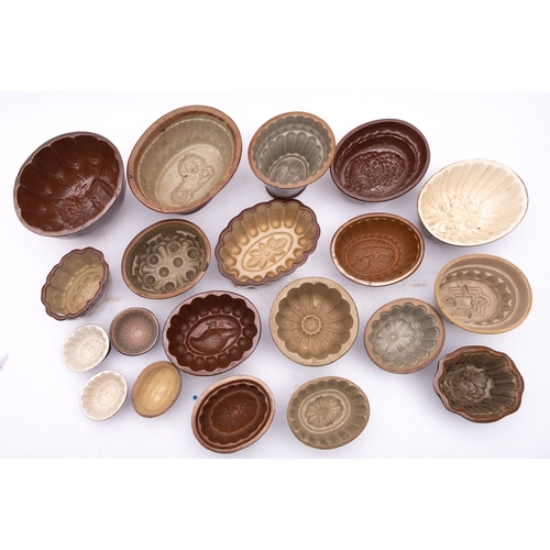 103 - A collection of brown glaze earthenware jelly moulds, various sizes and patterns, including partridg... 