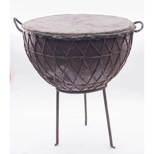 1411 - A large Middle Eastern, Oman, kettle stye drum, the steel  body with  hide skin and binding supporte... 