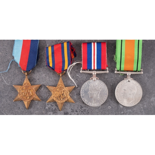 302 - A collection of WWII service medals with postage boxes.